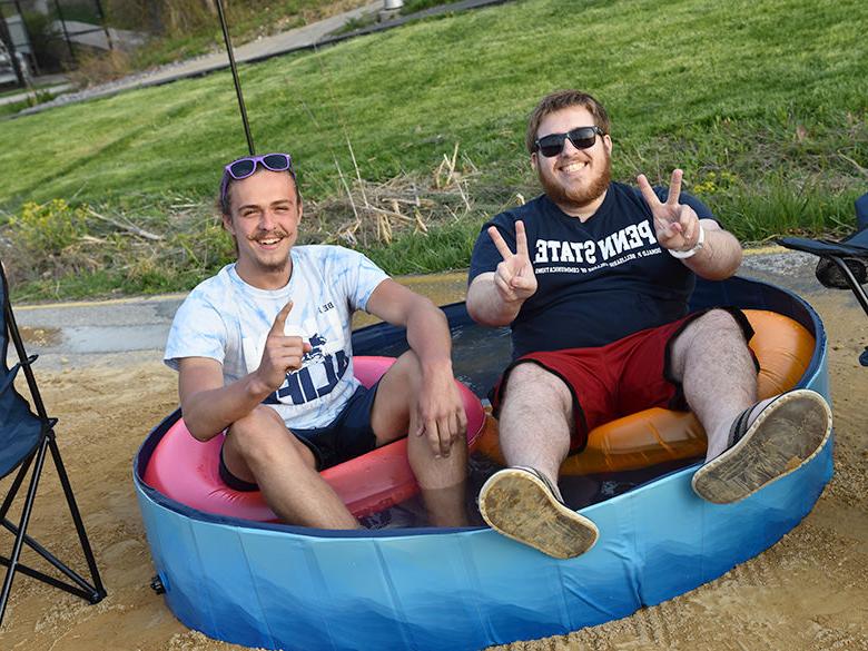 Students soaking in a mini pool at the Penn State Altoona Beach Party celebration