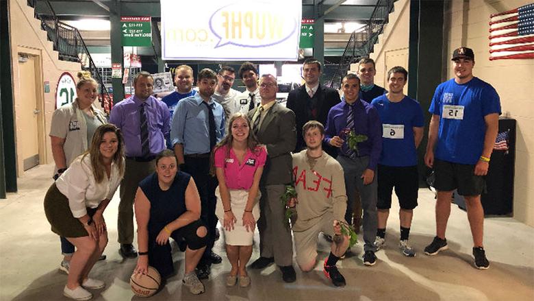 Scarcelli, center with white shirt and black tie, poses with several other interns at the Altoona Curve.